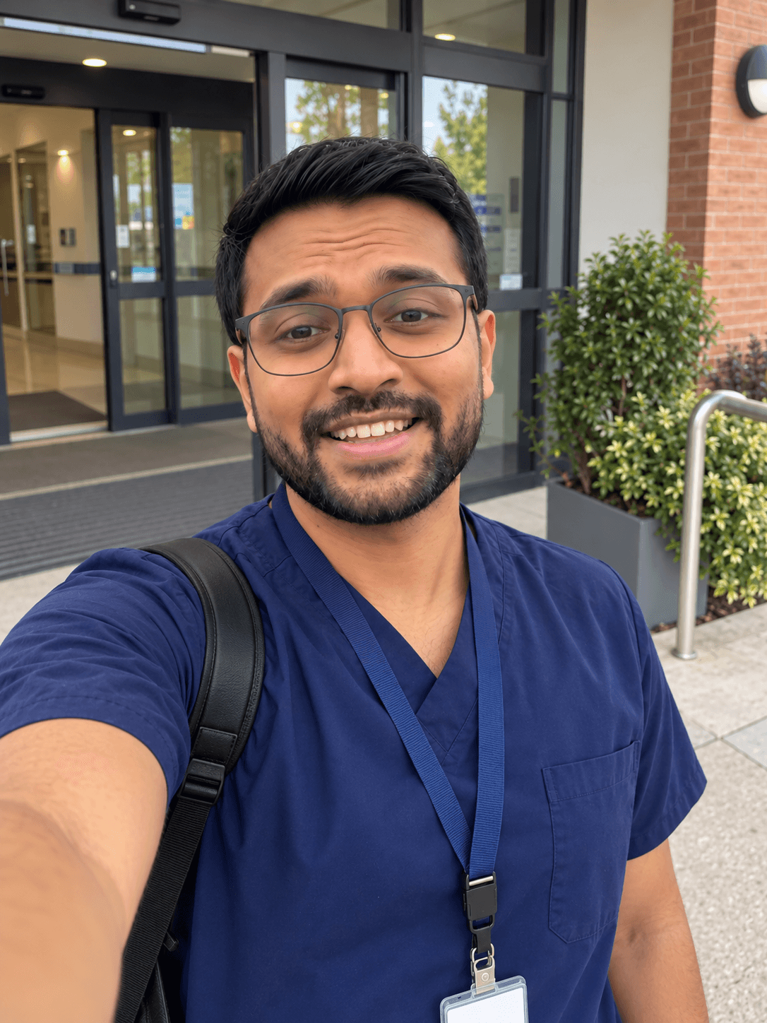 Hussain in his care work scrubs outside work